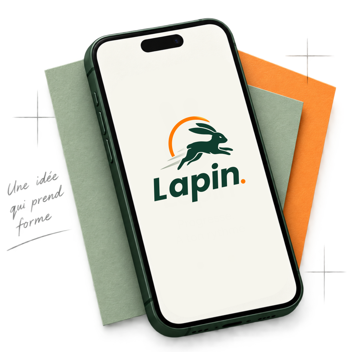 Téléphone affichant l'écran d'accueil de Lapin, posé sur des feuilles de papier sauge et orange, avec la note manuscrite : Une idée qui prend forme.